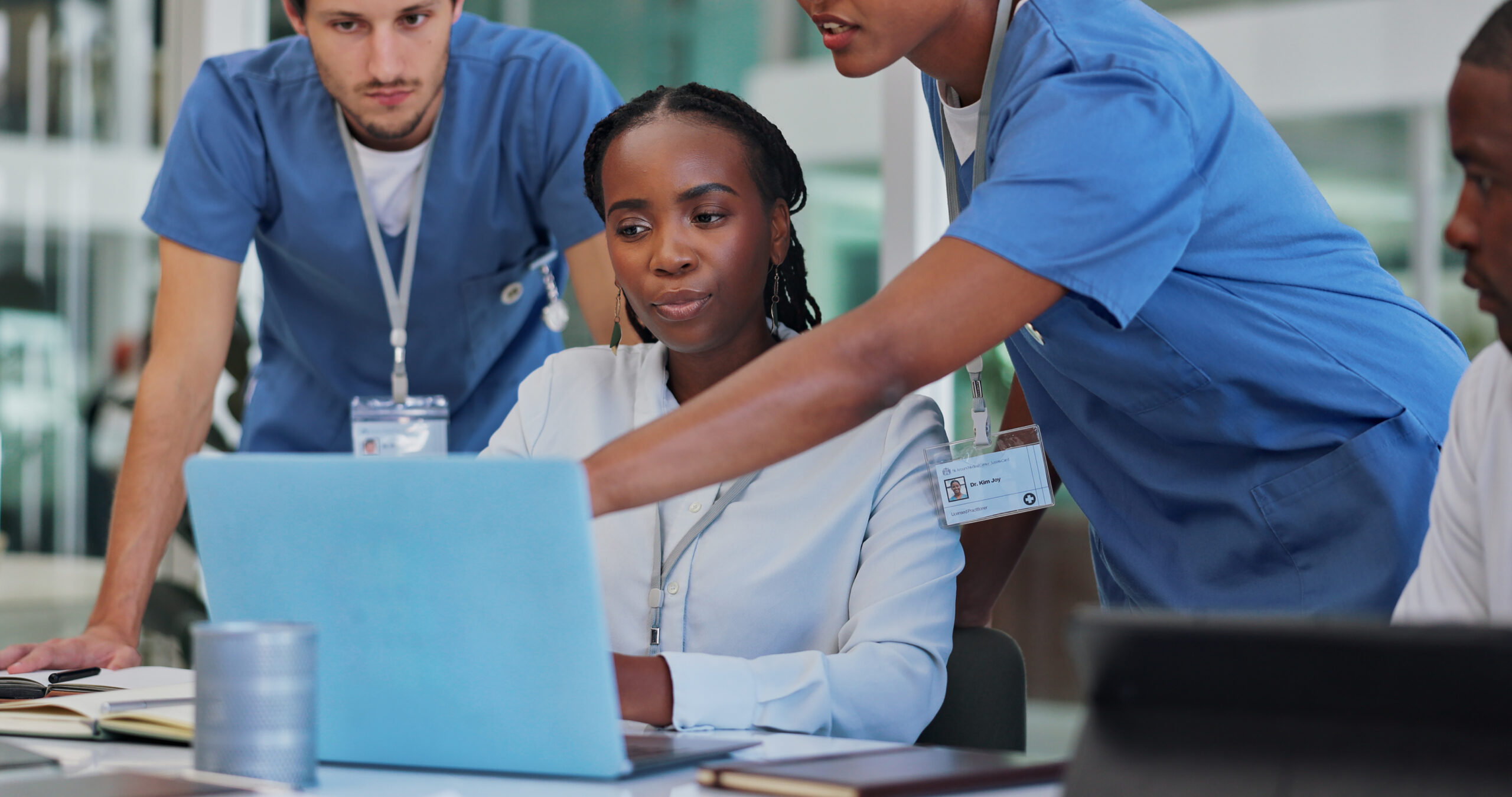 Nursing professionals pointing at computer